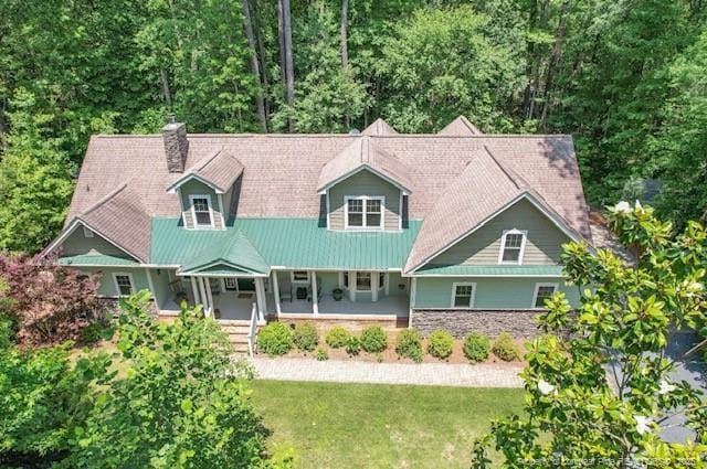 654 Titmouse Ct, Vass, NC 28394 - view of front of property featuring covered porch, a front lawn, a chimney, and a metal roof