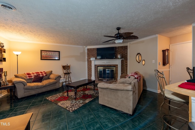 living room featuring a fireplace, a textured ceiling, ceiling fan, and crown molding