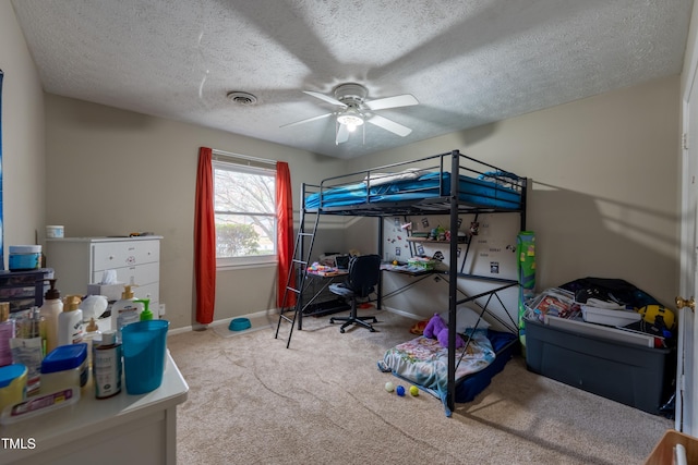 carpeted bedroom with a textured ceiling and ceiling fan