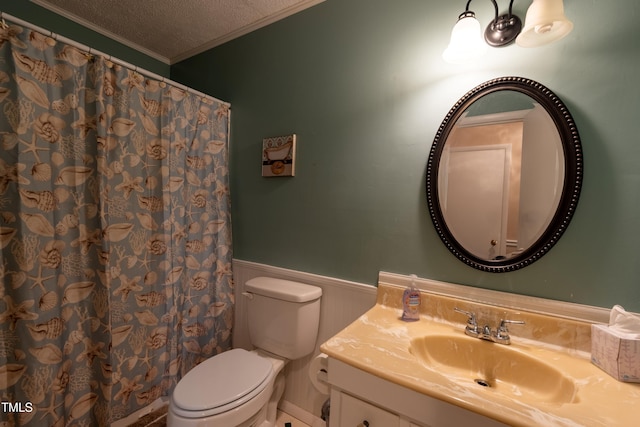 bathroom featuring crown molding, vanity, a textured ceiling, and toilet