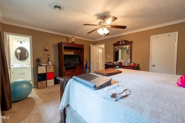 carpeted bedroom featuring a textured ceiling, ensuite bath, ceiling fan, and ornamental molding