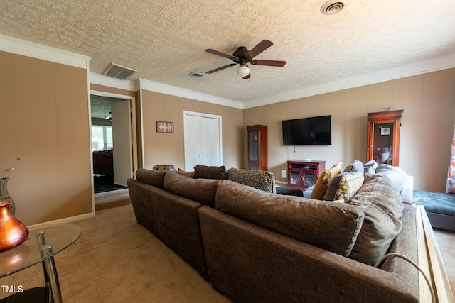 living room with a textured ceiling, ceiling fan, and crown molding