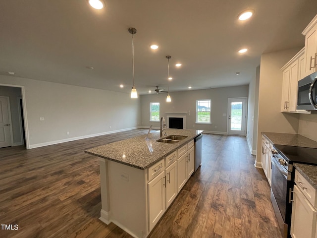 kitchen featuring white cabinetry, sink, ceiling fan, stainless steel appliances, and an island with sink