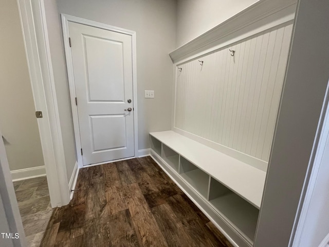 mudroom with dark wood-style floors and baseboards