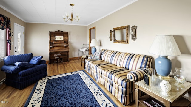 living room with hardwood / wood-style floors, an inviting chandelier, and crown molding