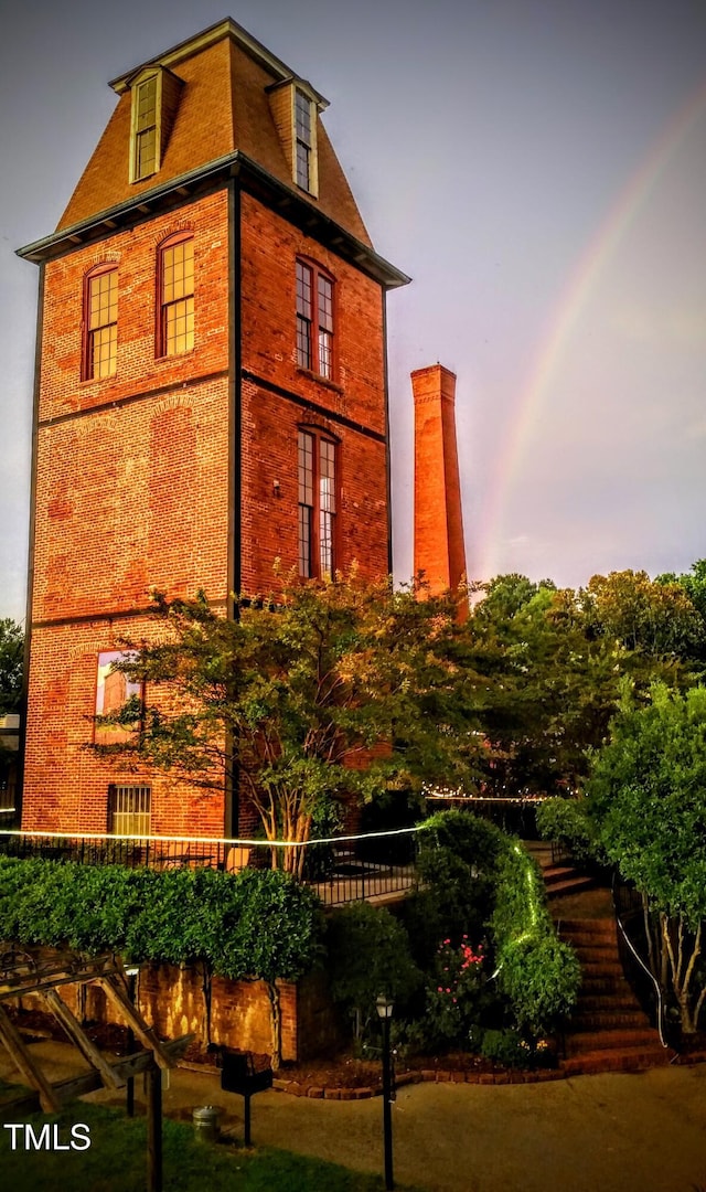 view of outdoor building at dusk