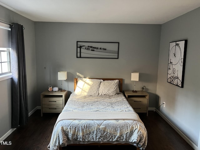 bedroom with dark wood-type flooring