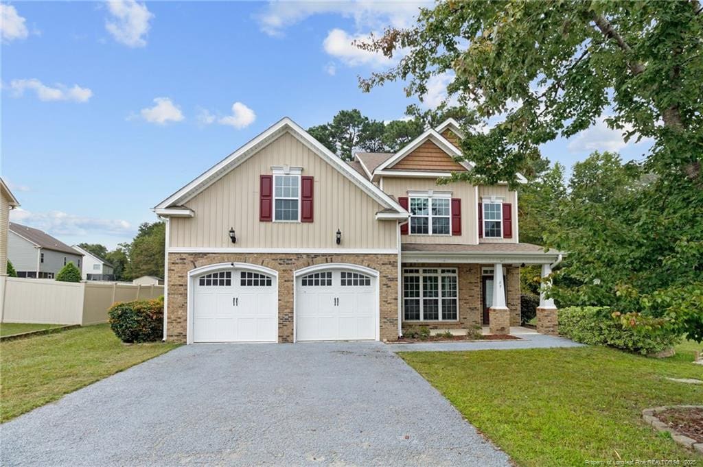 craftsman-style home featuring a front yard and a garage