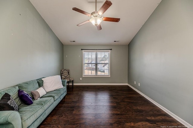 living room featuring ceiling fan and dark wood-type flooring