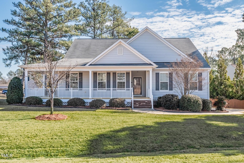 view of front of house with a porch and a front lawn