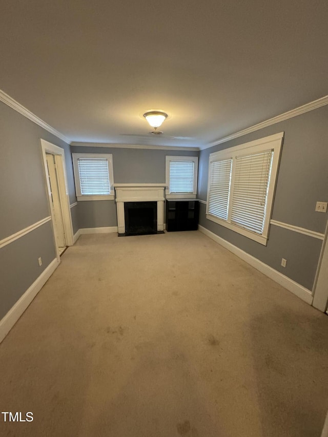 unfurnished living room with light colored carpet and crown molding