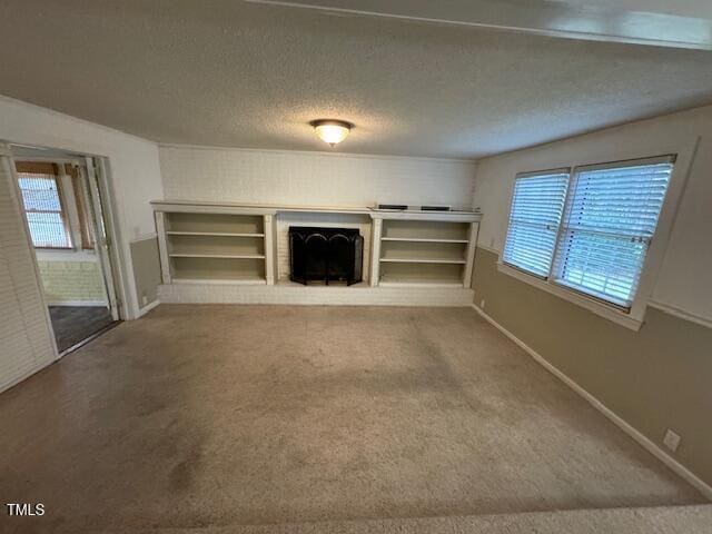 unfurnished living room with carpet, a textured ceiling, and a fireplace