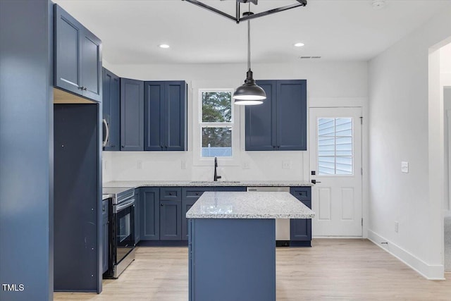 kitchen with a center island, sink, hanging light fixtures, stainless steel appliances, and light stone counters