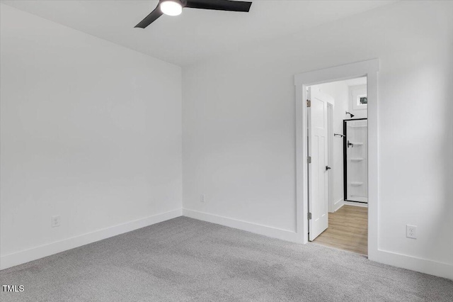 unfurnished room with light colored carpet and ceiling fan