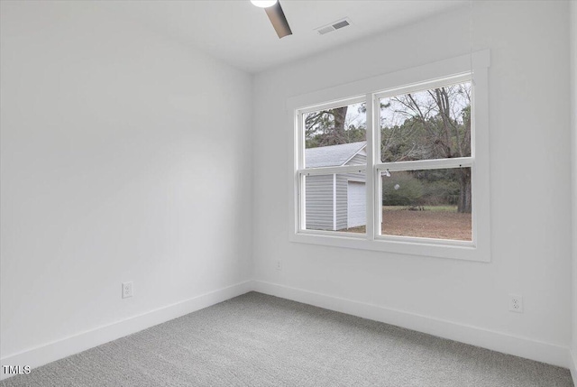 unfurnished room featuring ceiling fan and carpet floors