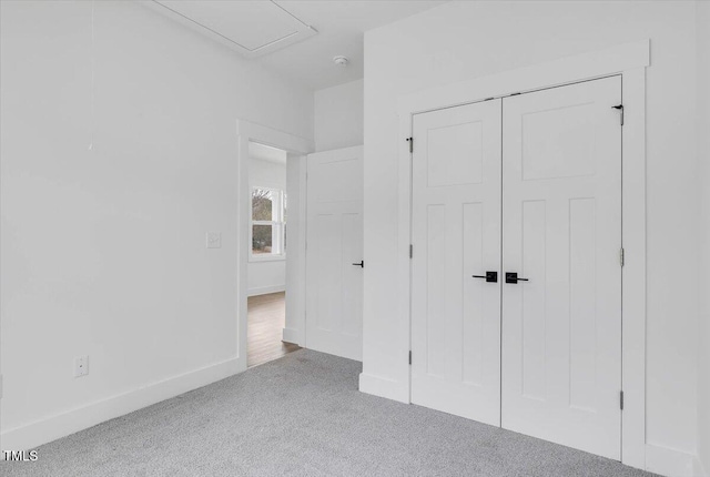 unfurnished bedroom featuring carpet floors and a closet