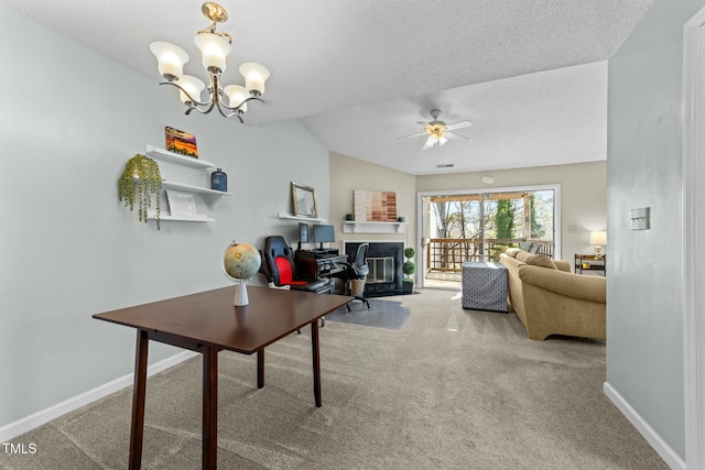 home office featuring vaulted ceiling, carpet flooring, ceiling fan with notable chandelier, and a textured ceiling