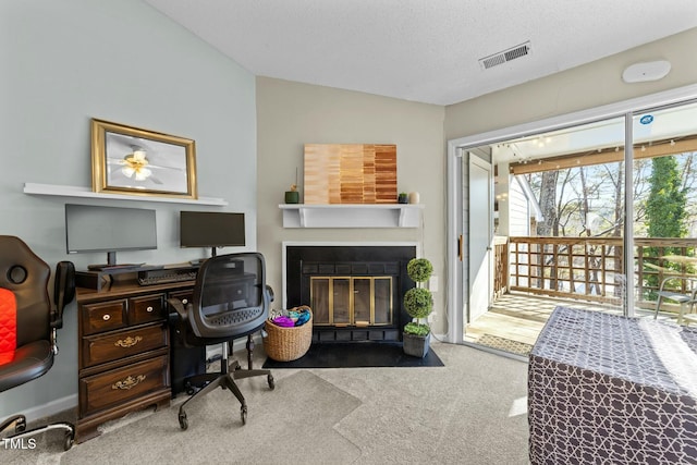 home office with carpet floors and a textured ceiling