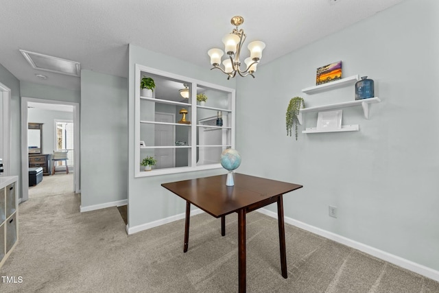 office space featuring carpet, a textured ceiling, and an inviting chandelier