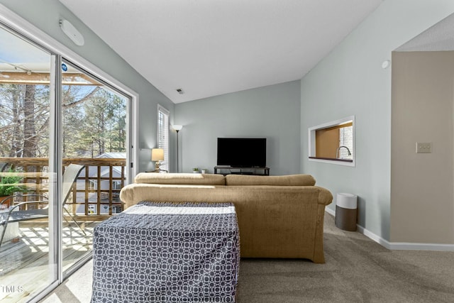 carpeted living room with vaulted ceiling