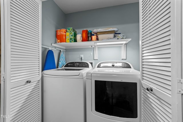 clothes washing area with washing machine and clothes dryer