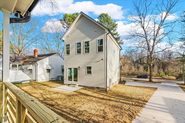rear view of house featuring central AC