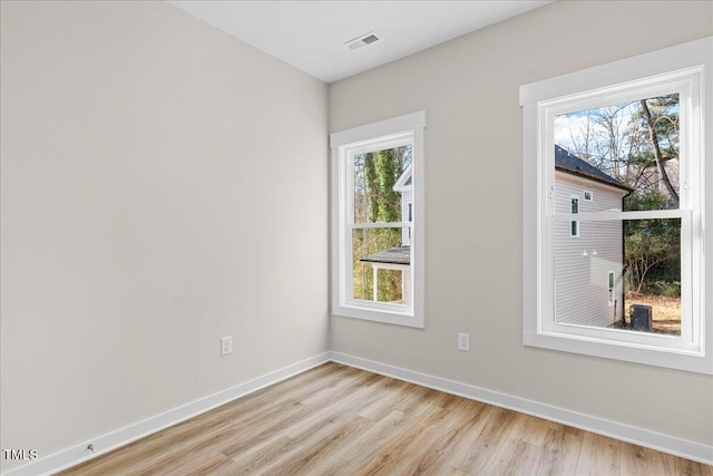 unfurnished room with light wood-type flooring