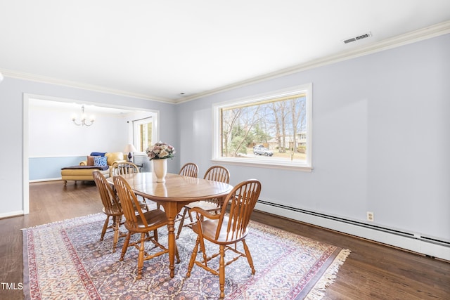 dining room featuring baseboard heating, a notable chandelier, ornamental molding, and hardwood / wood-style flooring