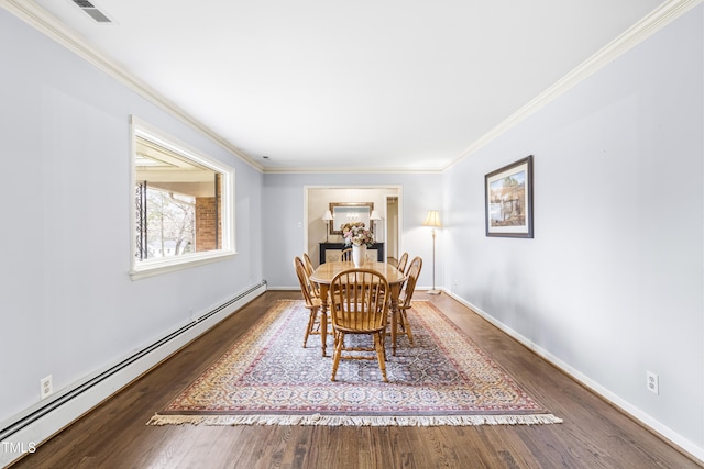 dining space with crown molding, hardwood / wood-style flooring, and baseboard heating