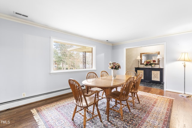 dining space with ornamental molding, dark hardwood / wood-style flooring, and a baseboard radiator