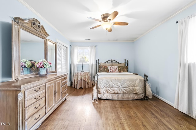 bedroom featuring ornamental molding, ceiling fan, and light wood-type flooring