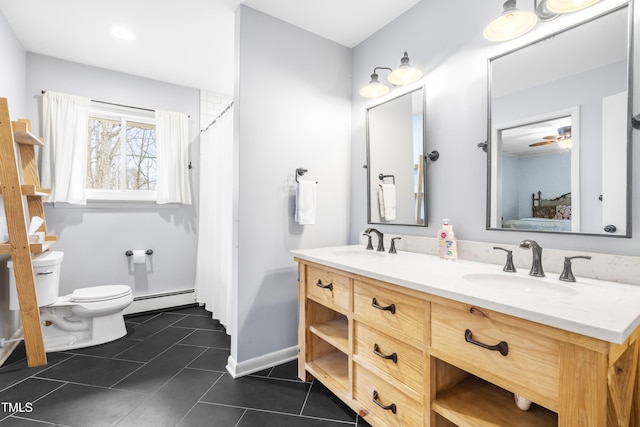 bathroom featuring tile patterned flooring, a baseboard heating unit, vanity, and toilet