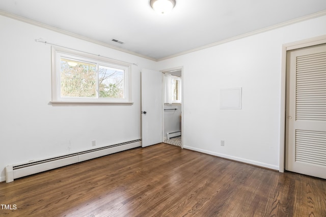 unfurnished bedroom with crown molding, dark hardwood / wood-style floors, a closet, and a baseboard heating unit