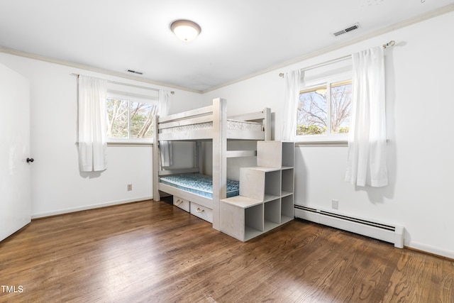 unfurnished bedroom with dark hardwood / wood-style flooring, ornamental molding, and baseboard heating