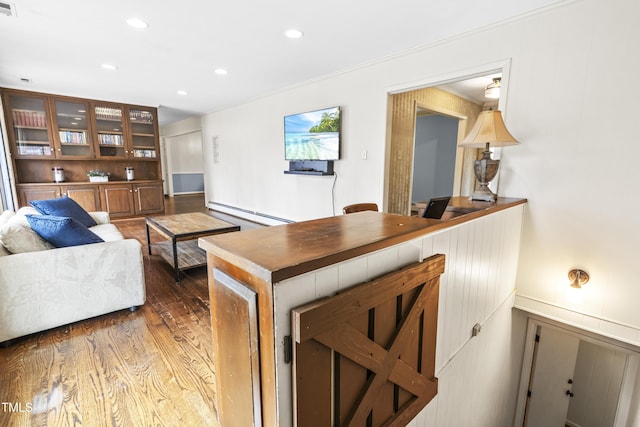 living room with dark hardwood / wood-style flooring and baseboard heating