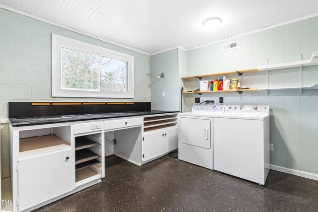 laundry area with ornamental molding and washing machine and dryer