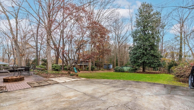 view of patio / terrace with a playground and a fire pit