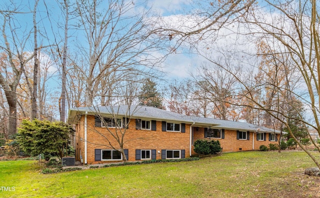 back of house featuring a lawn and central air condition unit