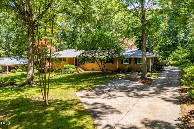 5205 Rembert Dr, Raleigh, NC 27612 - single story home featuring crawl space, a front yard, and brick siding