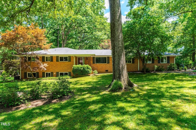 5205 Rembert Dr, Raleigh, NC 27612 - single story home featuring a front yard, crawl space, and brick siding