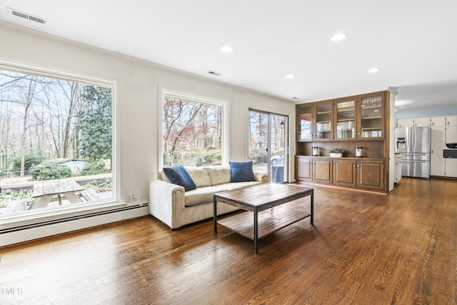 5205 Rembert Dr, Raleigh, NC 27612 - living area with healthy amount of natural light, a baseboard heating unit, recessed lighting, dark wood-type flooring, and ornamental molding