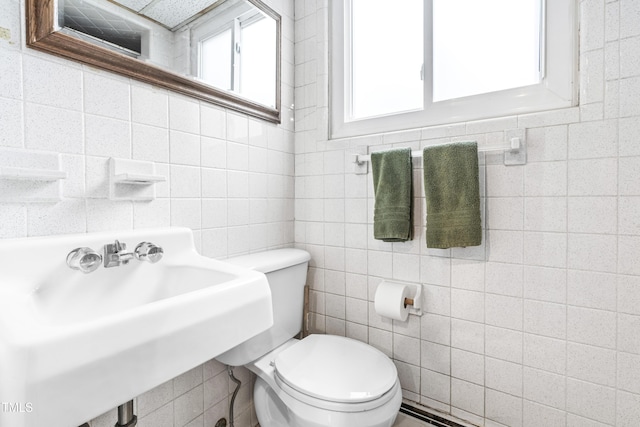 5205 Rembert Dr, Raleigh, NC 27612 - bathroom with tile walls, toilet, and a sink