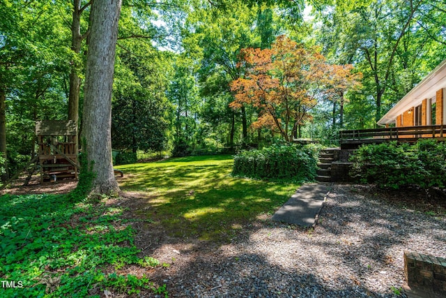 5205 Rembert Dr, Raleigh, NC 27612 - view of green lawn featuring a deck