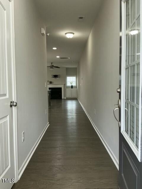 corridor featuring dark hardwood / wood-style floors