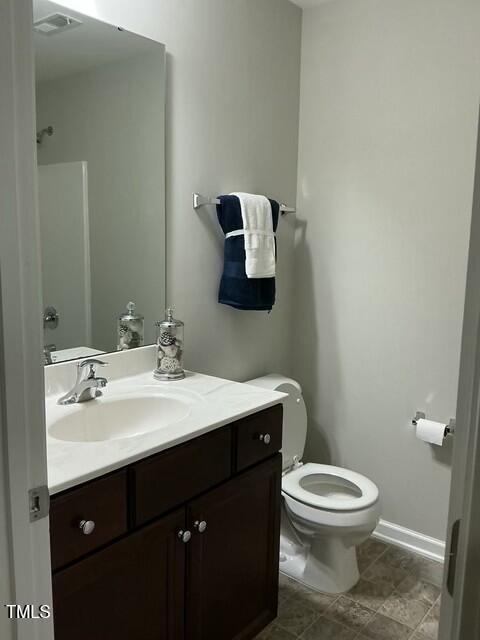 bathroom with vanity and toilet