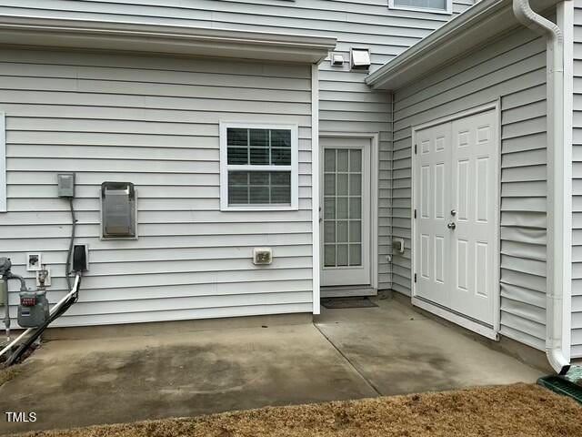 entrance to property featuring a patio