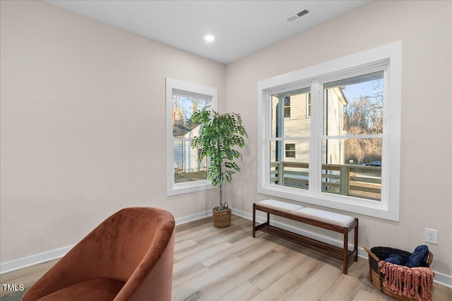 sitting room featuring light hardwood / wood-style flooring