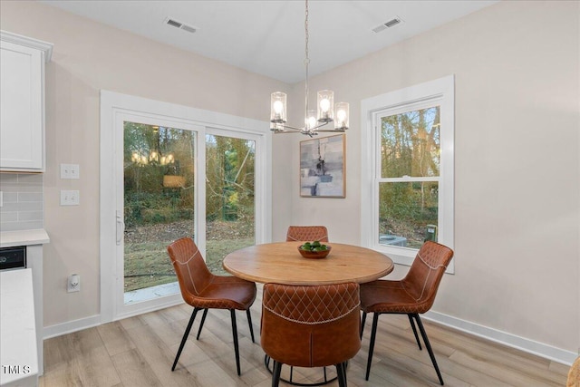 dining room with a chandelier and light wood-type flooring