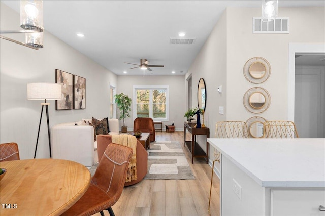 dining area featuring light hardwood / wood-style floors and ceiling fan