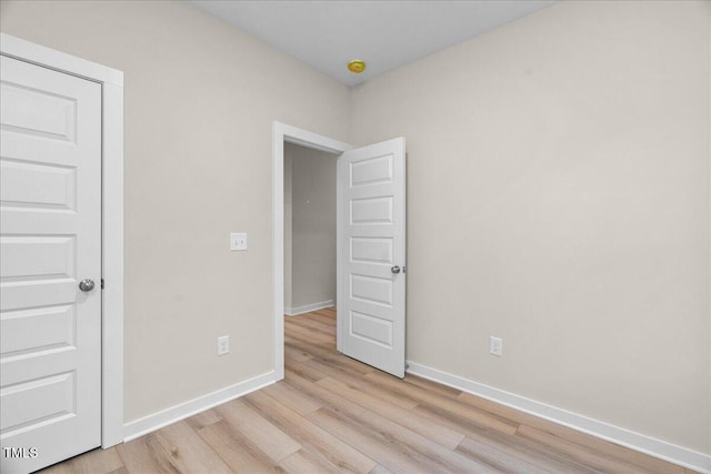 spare room featuring light hardwood / wood-style flooring